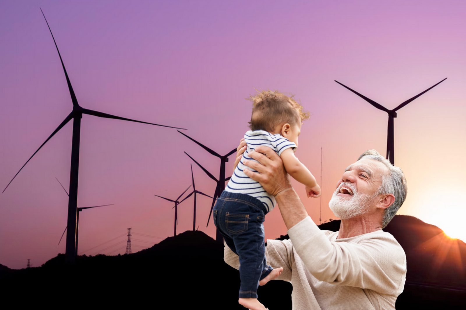 Un grand-père rieur soulève sa petite-fille dans les airs, devant des éoliennes sur une colline au coucher du soleil.